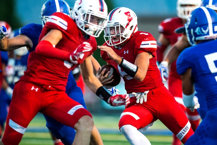 (Chris Detrick  |  The Salt Lake Tribune)  East's Ben Ford (8) runs the ball past Bingham's Dax Milne (5) during the game at Bingham High School Friday, August 25, 2017. Bingham is winning the game 24-17 at halftime. 