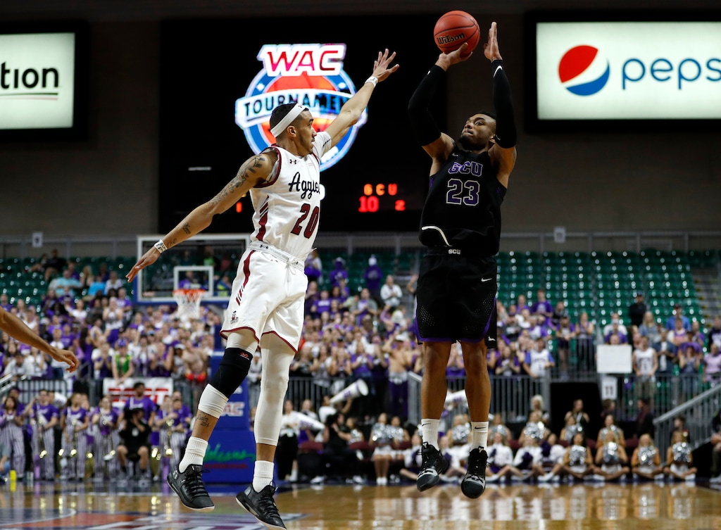Grand Canyon's Carlos Johnson (23) shoots over New Mexico State guard Trevelin Queen (20) during an NCAA college basketball game for the Western Athletic Conference men's tournament championship Saturday, March 16, 2019, in Las Vegas. (AP Photo/Steve Marcus)