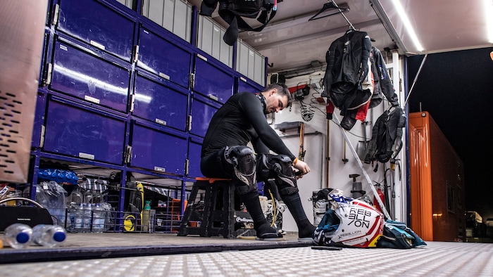 (Photo courtesy of Ishaan Bhataiya/BAS Trucks Dakar Racing Team)
Skyler Howes of St. George dresses in the trailer of his BAS Trucks team prior to racing through the dunes of Saudi Arabia during an early stage of the Dakar Rally in January 2021. Howes took the overall lead on Stage 3 and is believed to be one of the first privateers to lead the standings in more than 30 years.