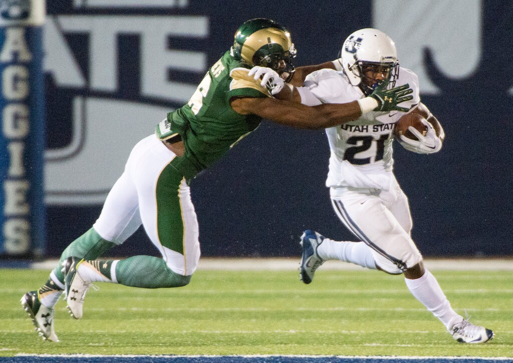 Rick Egan | The Salt Lake Tribune
Colorado State Rams safety Trent Matthews (16) tries to bring down Utah State Aggies running back LaJuan Hunt (21), in college football action, Utah State vs Colorado State at Maverik Stadium in Logan, Saturday, October 3, 2015.