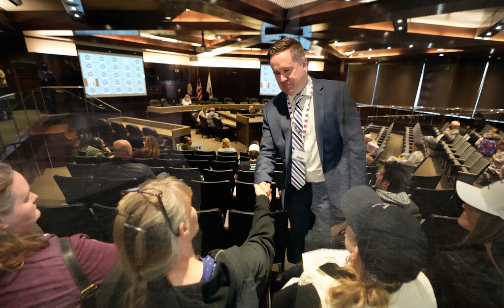 (Francisco Kjolseth | The Salt Lake Tribune) Salt Lake County Council member Dave Alvord shakes hands with people gathered inside the Salt Lake County Government Center chamber in 2022.