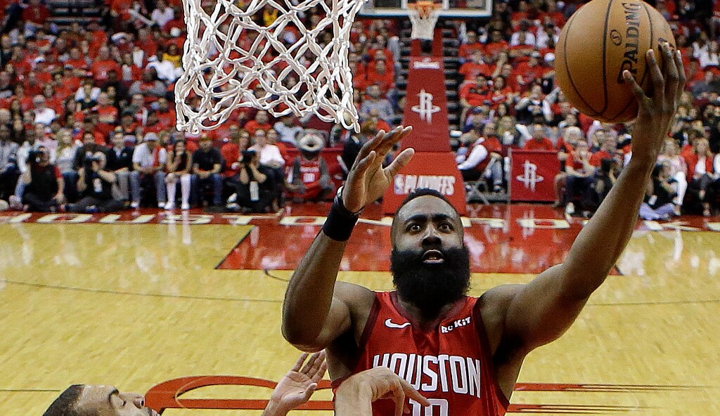 Houston Rockets guard James Harden (13) drives to the basket as Utah Jazz center Rudy Gobert defends during the second half of Game 1 of an NBA basketball first-round playoff series, Sunday, April 14, 2019, in Houston. Houston won the game 122-90. (AP Photo/Eric Christian Smith)