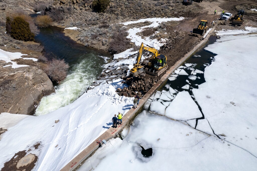 (Rick Egan | The Salt Lake Tribune) Workers move earth to secure the rim of the Panguitch Lake Dam on Thursday, April 11, 2024. The Federal Emergency Management Agency just awarded $7.2 million to Utah to rehabilitate high-hazard dams across the state.