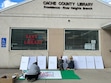 (Spencer Wilkinson | Utah Public Radio) Residents make signs at the Cache County Library after learning about a 2026 budget proposal that would cut the library's funding.