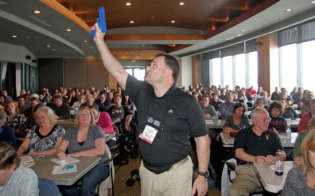(Rick Bowmer | The Associated Press) In this Thursday, Dec. 27, 2012, file photo, Clark Aposhian, president of the Utah Shooting Sport Council, holds a plastic gun during a concealed weapons training session for 200 Utah teachers in West Valley City. The council offered six hours of training in handling concealed weapons in an effort to arm teachers to confront school assailants.