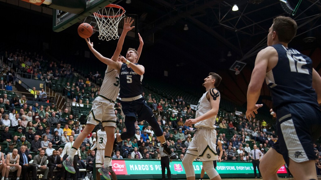 Utah State guard Sam Merrill (5) draws a foul from Colorado State forward Adam Thistlewood (31) during an NCAA college basketball game Tuesday, March 5, 2019, in Fort Collins, Colo (Timothy Hurst/The Coloradoan via AP)