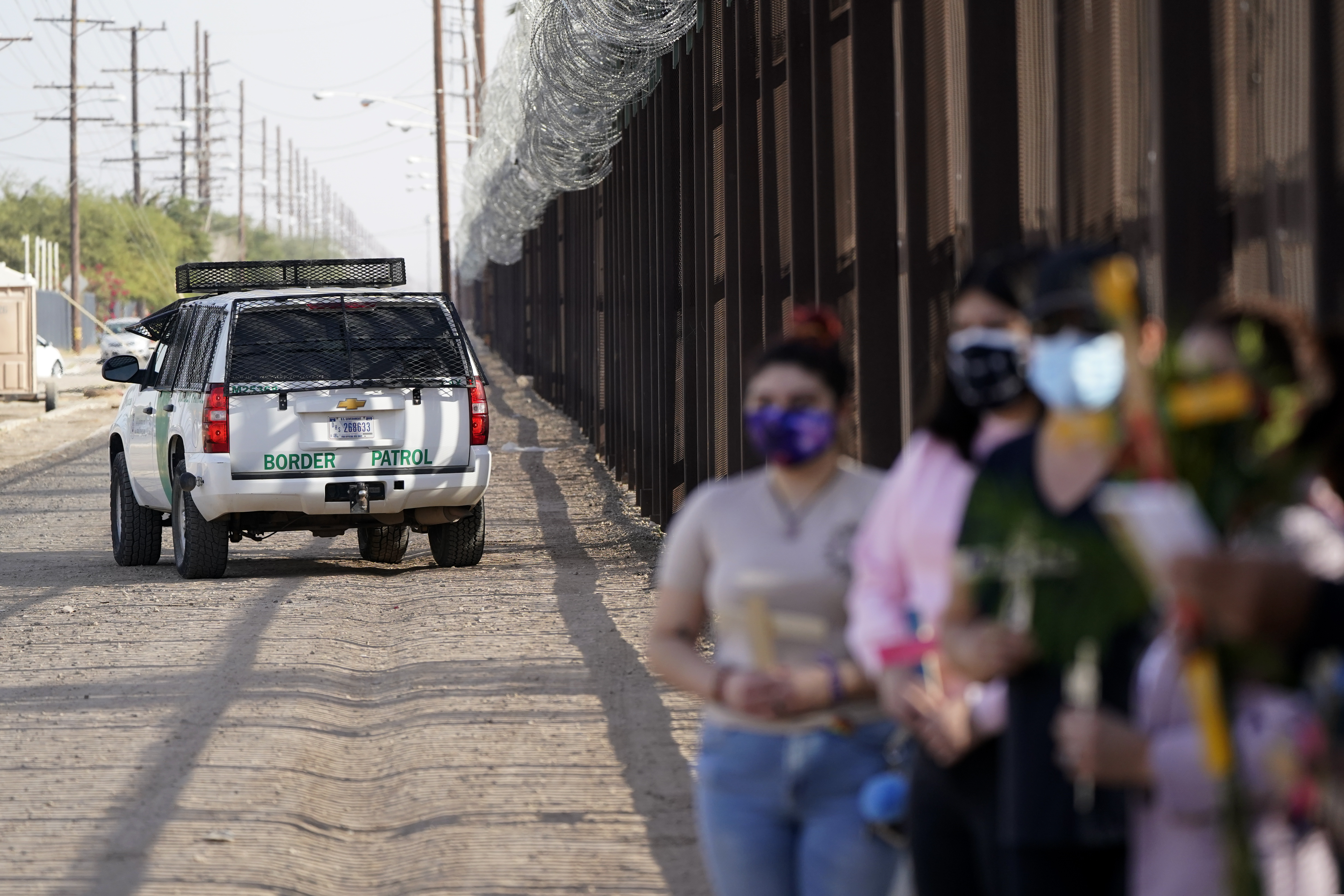 (Gregory Bull | The Associated Press) People attend an event in honor of the Virgin of Guadalupe along the border Saturday, Dec. 12, 2020, in Calexico, Calif.