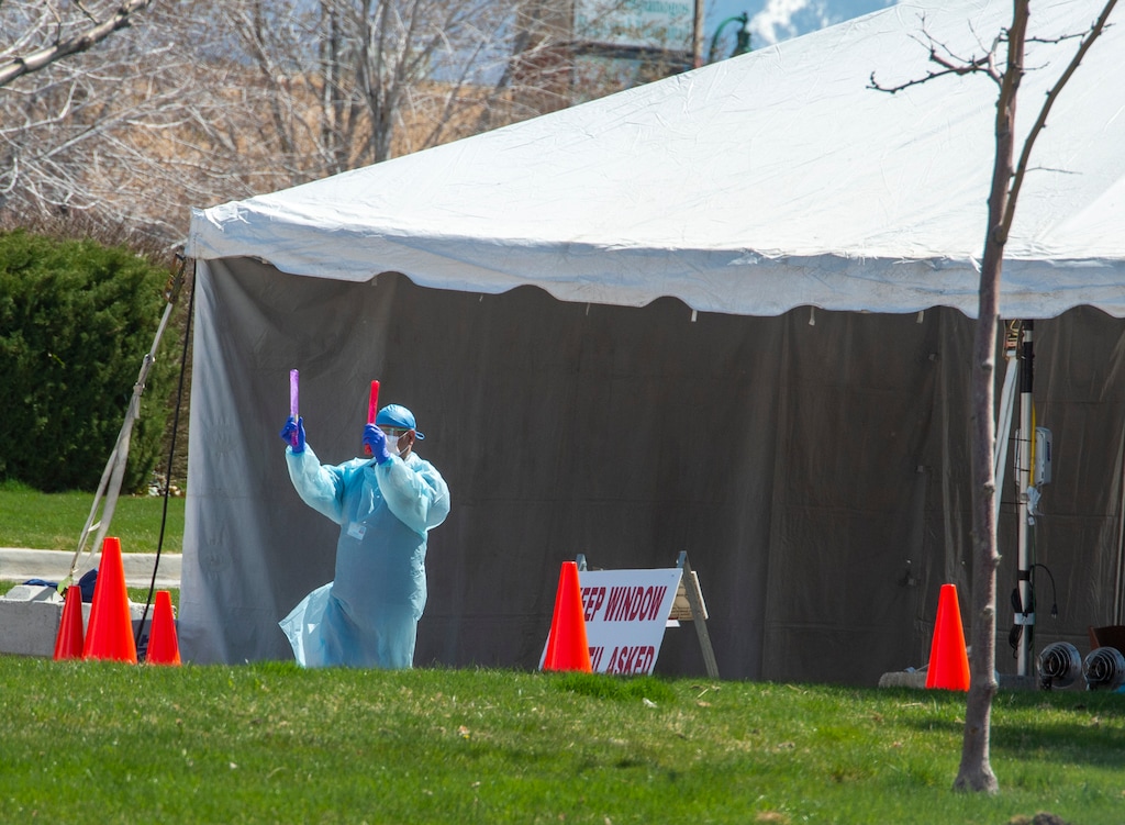 (Rick Egan  |  The Salt Lake Tribune)      Cars are directed in to the tent for drive-thru testing at the Timpanogos Regional Medical Center in Orem, Tuesday April 7, 2020