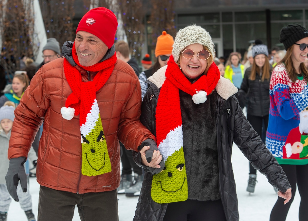 (Rick Egan  |  The Salt Lake Tribune) Warren Rizzo and Julie Quinn from Phoenix, Ariz., skate at the Gallivan Center on Christmas Eve, Tuesday, Dec. 24, 2019. Julie has been skating with her family on Christmas Eve for the past 35 years. Her mother made everyone in her family Grinch scarves so she can tell them apart from the other skaters.