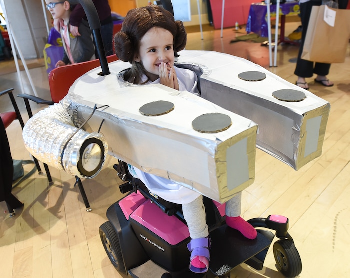 (Francisco Kjolseth  |  The Salt Lake Tribune)  Annika Ellefsen, 4, is all smiles as Princess Leia in her Millennium Falcon as volunteers and staff at Shriners Hospital for Children in Salt Lake transform the wheelchairs of 28 patients for Halloween, Wednesday, Oct. 17, 2018. Annika, who has spina bifida, loves her visits to Shriner's, according to her mother, Jennifer. Last year her wheelchair was transformed into a princess carriage and "she beamed all night long," exclaimed her mother.