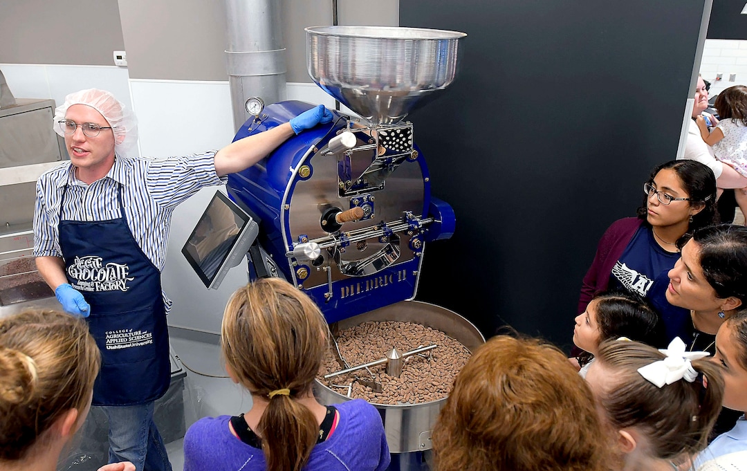 (Eli Lucero  |  The Herald Journal) Zachary Cooper talks about how they roast cocoa beans during a public tour of the Aggie Chocolate Factory on Tuesday in Logan.