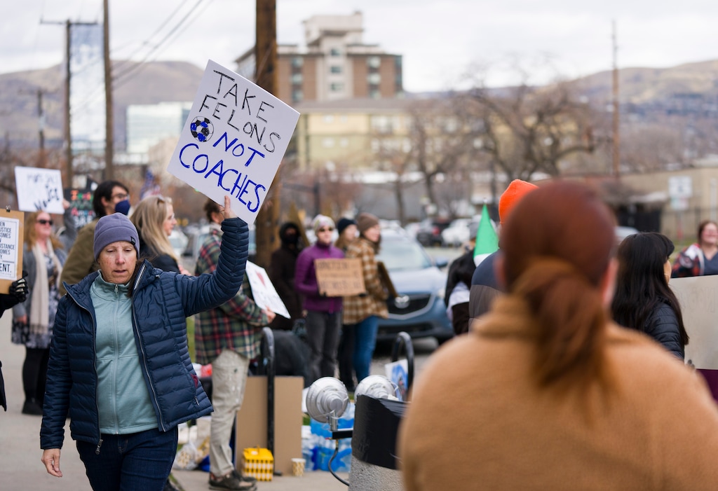 (Bethany Baker  |  The Salt Lake Tribune) Protesters gather outside of the U.S. Citizenship and Immigration Services building in Salt Lake City on Monday, Dec. 8, 2025.