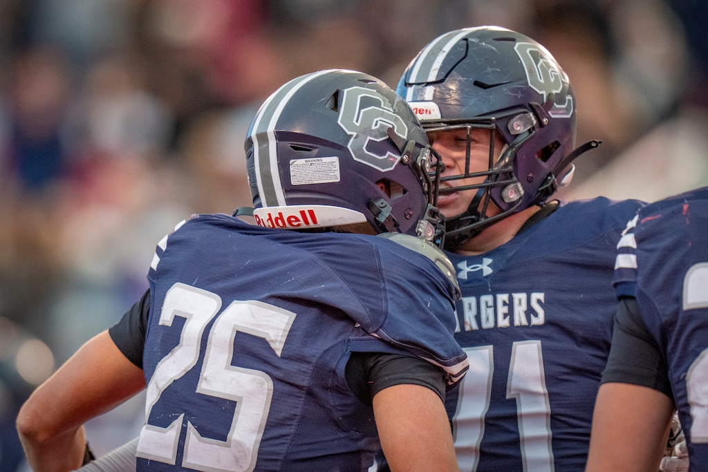 (Rick Egan | The Salt Lake Tribune) Corner Canyon running back Weston Briggs (25) celebrates his touchdown with  Will Chandler (71) in the 6A Championship game at Rice-Eccles Stadium.