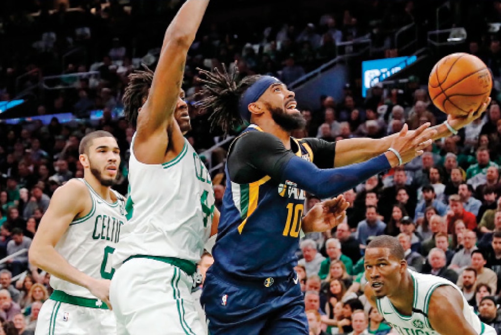 Utah Jazz's Mike Conley (10) goes to the basket past Boston Celtics' Robert Williams III during the first quarter of an NBA basketball game Friday, March 6, 2020, in Boston. (AP Photo/Winslow Townson)