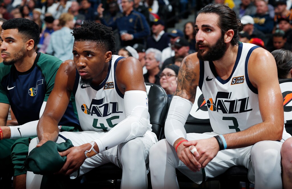 Utah Jazz guards Donovan Mitchell, left, and Ricky Rubio sit on the bench at the close of the team's NBA basketball game against the Denver Nuggets on Saturday, Nov. 3, 2018, in Denver. The Nuggets won 103-88. (AP Photo/David Zalubowski)