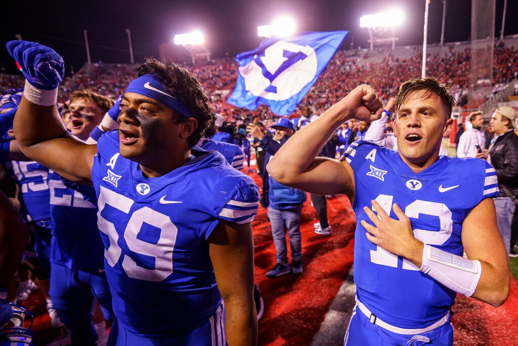(Trent Nelson  |  The Salt Lake Tribune) Brigham Young Cougars quarterback Jake Retzlaff (12) and teammates celebrate the win as Utah hosts BYU, NCAA football in Salt Lake City on Sunday, Nov. 10, 2024.