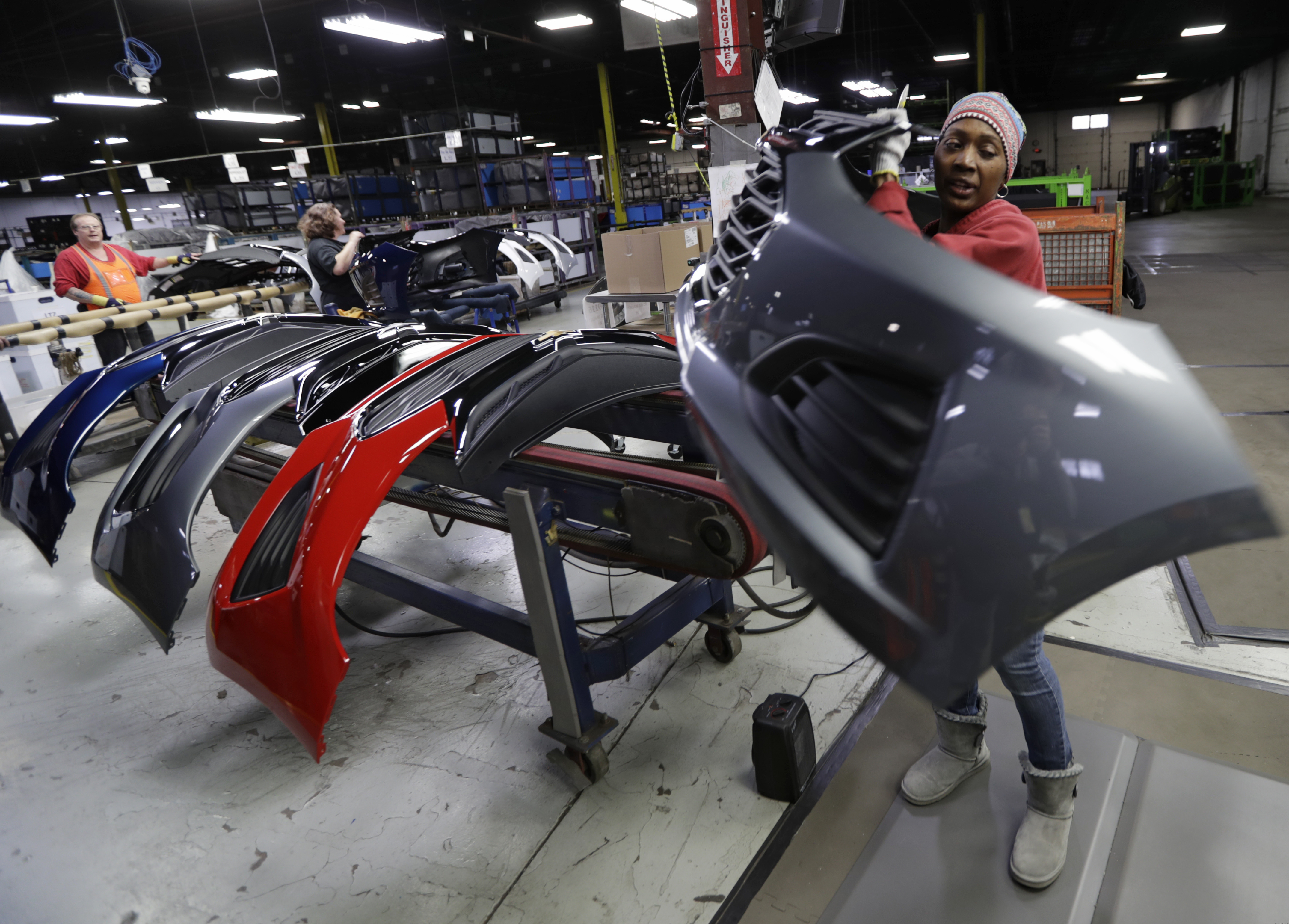 Mari Keels transfers a front end of a General Motors Chevrolet Cruze during assembly at Jamestown Industries, Wednesday, Nov. 28, 2018, in Youngstown, Ohio. Jamestown Industries supplies parts for the Chevy Cruze. GM said Monday that Lordstown will stop making the Chevy Cruze by March, at a cost of 1,400 union jobs on top of the 2,700 lost there since President Donald Trump took office. (AP Photo/Tony Dejak)