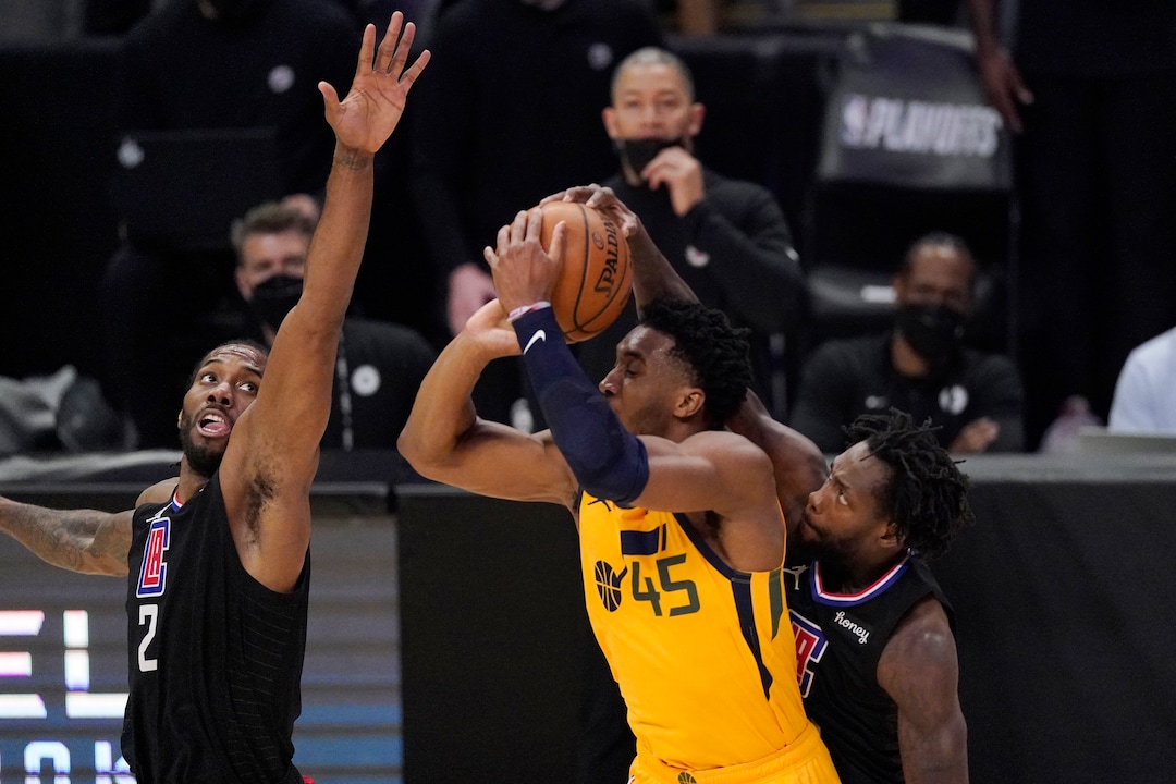 Utah Jazz guard Donovan Mitchell, center, has his shot blocked by Los Angeles Clippers guard Patrick Beverley, right, as forward Kawhi Leonard defends during the first half in Game 4 of a second-round NBA basketball playoff series Monday, June 14, 2021, in Los Angeles. (AP Photo/Mark J. Terrill)
