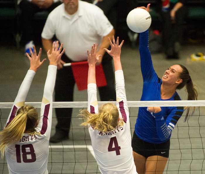 (Rick Egan  |  The Salt Lake Tribune)   Pleasant Grove Vikings Kazna Tarawhiti (16) hits the ball, as Pleasant Grove Vikings Megan Sintay (18) and Alia Rasmussen (4), defend, in 6A volleyball championship action, Pleasant Grove vs. Lone Peak, at Utah Valley University, Saturday, November 4, 2017.