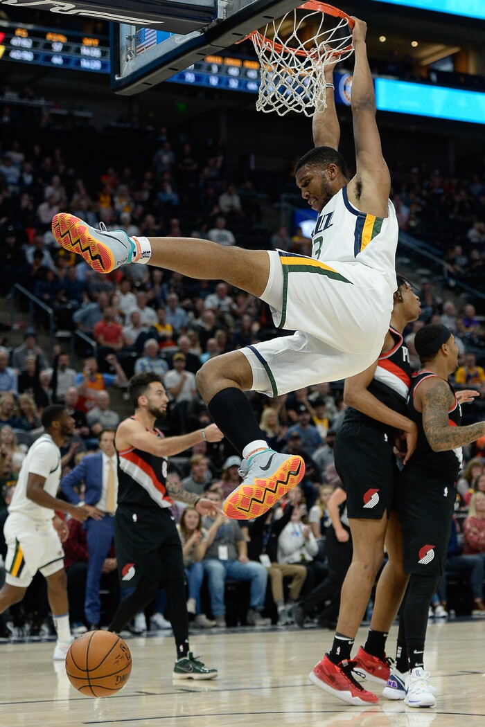 (Francisco Kjolseth  |  The Salt Lake Tribune)  Utah Jazz center Tony Bradley (13) spends a little extra time on the rim after a dunk as the Utah Jazz host the Portland Trailblazers in their NBA basketball game at Vivint Smart Home Arena in Salt Lake City on Wed. Oct. 16, 2019.