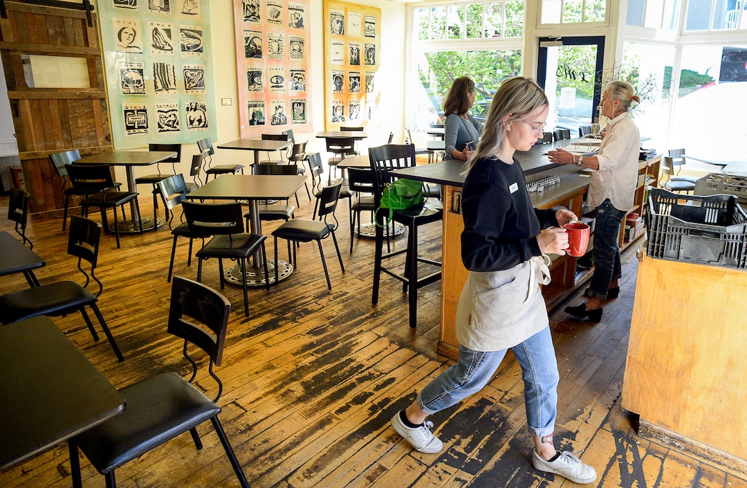 (Francisco Kjolseth  |  The Salt Lake Tribune)  Amber Dwyer delivers drinks from The Dayroom coffee shop through the adjacent Em's restaurant on her way to a large shared patio on the other side near the state capital.