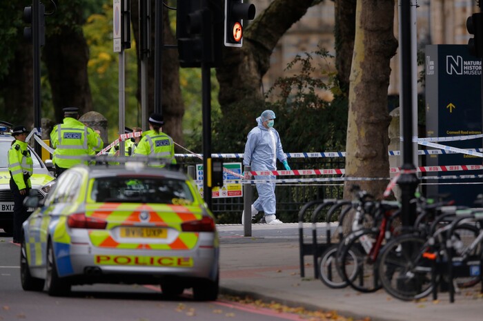 Britain's Police and a forensic investigator at the scene of an incident in central London, Saturday, Oct. 7, 2017. London police say emergency services are outside the Natural History Museum in London after a car struck pedestrians. (AP Photo/Alastair Grant)