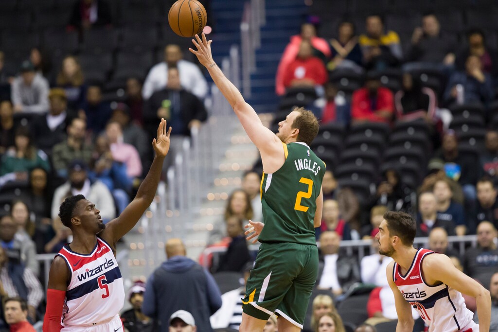 Utah Jazz forward Joe Ingles (2), from Australia, shoots between Washington Wizards forward Bobby Portis (5) and guard Tomas Satoransky (31), from the Czech Republic, during the first half of an NBA basketball game Monday, March 18, 2019, in Washington. (AP Photo/Alex Brandon)