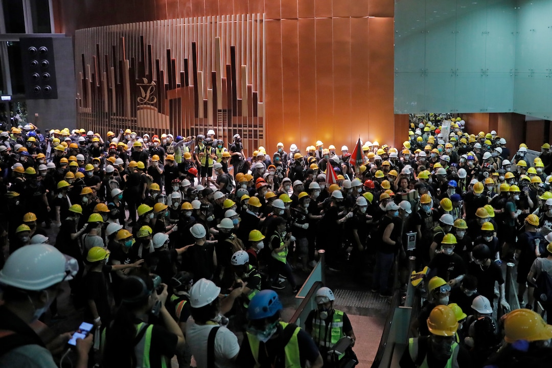 (Kin Cheung | AP Photo) Protesters gather inside the Legislative Council building in Hong Kong, Monday July 1, 2019. Protesters in Hong Kong took over the legislature's main building Monday night, tearing down portraits of legislative leaders and spray painting pro-democracy slogans on the walls of the main chamber.