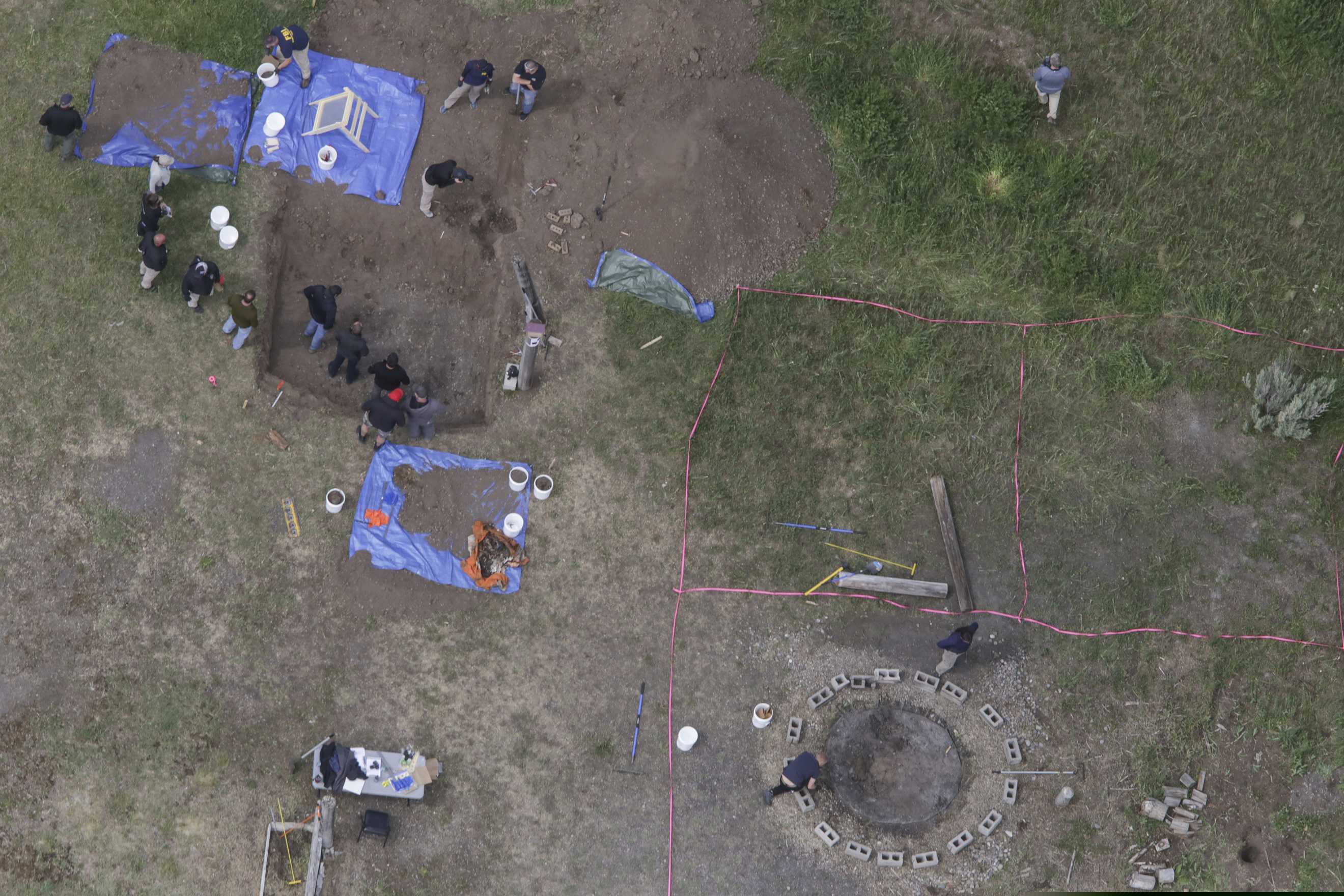 (John Roark | The Idaho Post-Register via AP) In this aerial photo, investigators search for human remains at Chad Daybell's residence in the 200 block of 1900 East, Tuesday, June 9, 2020, in Salem, Idaho. Authorities say they uncovered human remains at Daybell's home as they investigated the disappearance of his new wife’s two children. Police in the small town of Rexburg say Daybell was taken into custody Tuesday. He had recently married the children’s mother, Lori Vallow Daybell, who has been charged with child abandonment.