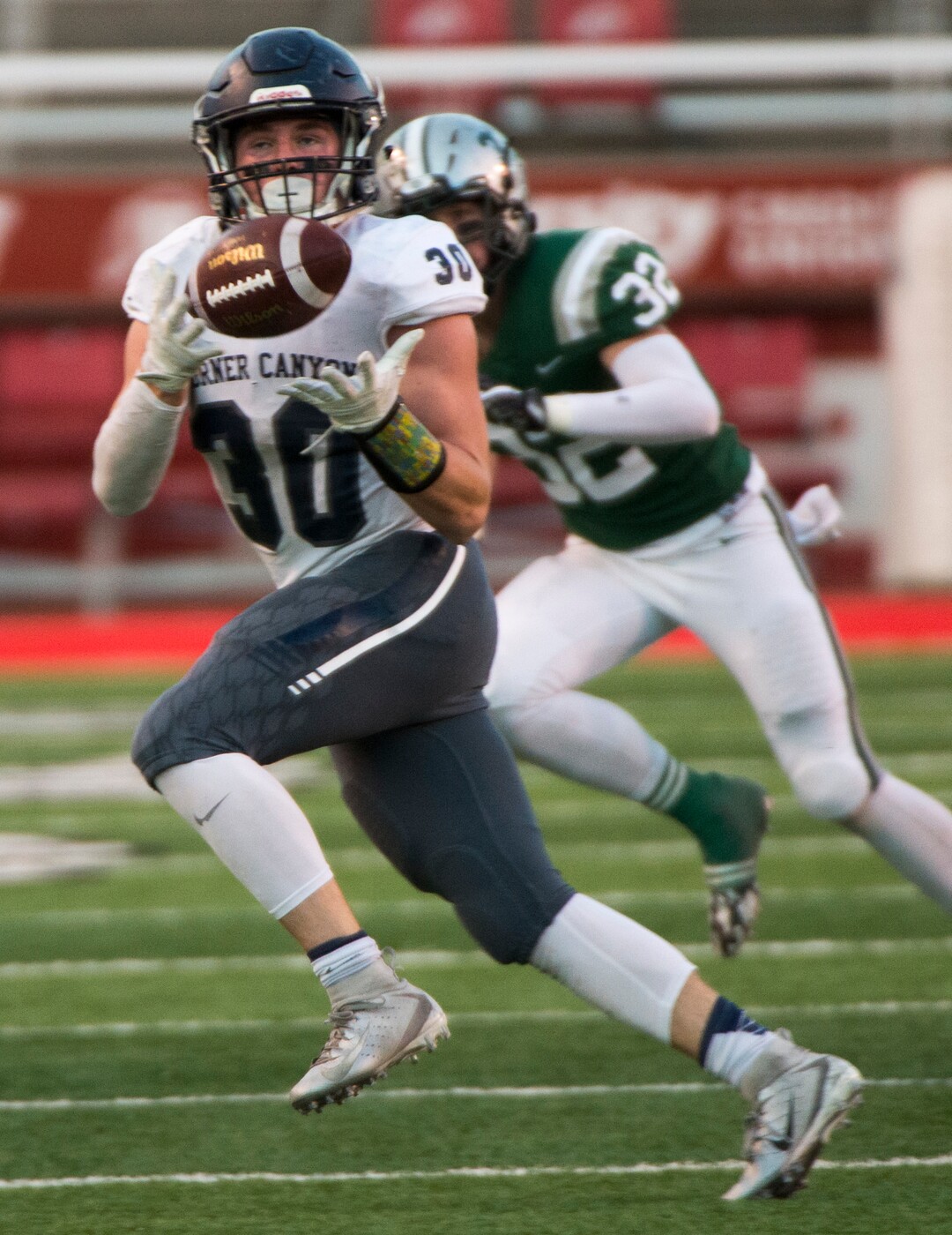 (Rick Egan  |  The Salt Lake Tribune)    Caden Johnson catches a pass for Corner Canyon as Jonah Pingree defends for the Titans, in 5A football semifinal action between Olympus and Corner Canyon at Rice-Eccles Stadium, Thursday, Nov. 8, 2018.