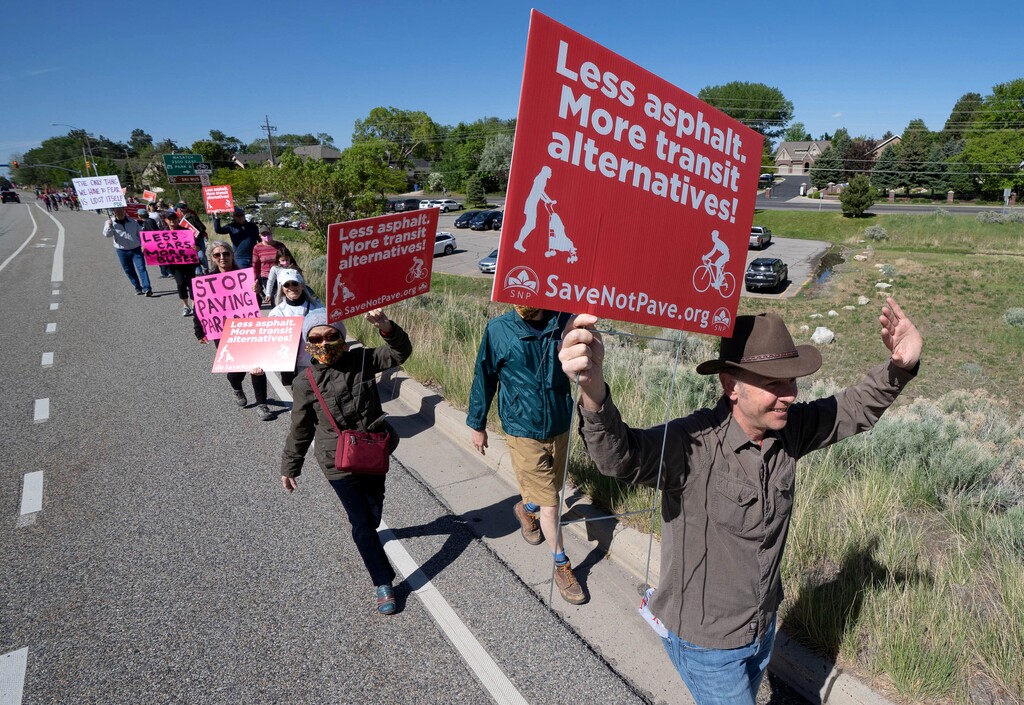 (Francisco Kjolseth | The Salt Lake Tribune) Eric Kraan, leads a group of people down Wasatch Blvd., for a Save Not Pave march and rally on Saturday, May 22, 2021, in opposition to the proposal to widening Wasatch Blvd., between the canyon section of Big and Little Cottonwood canyon.