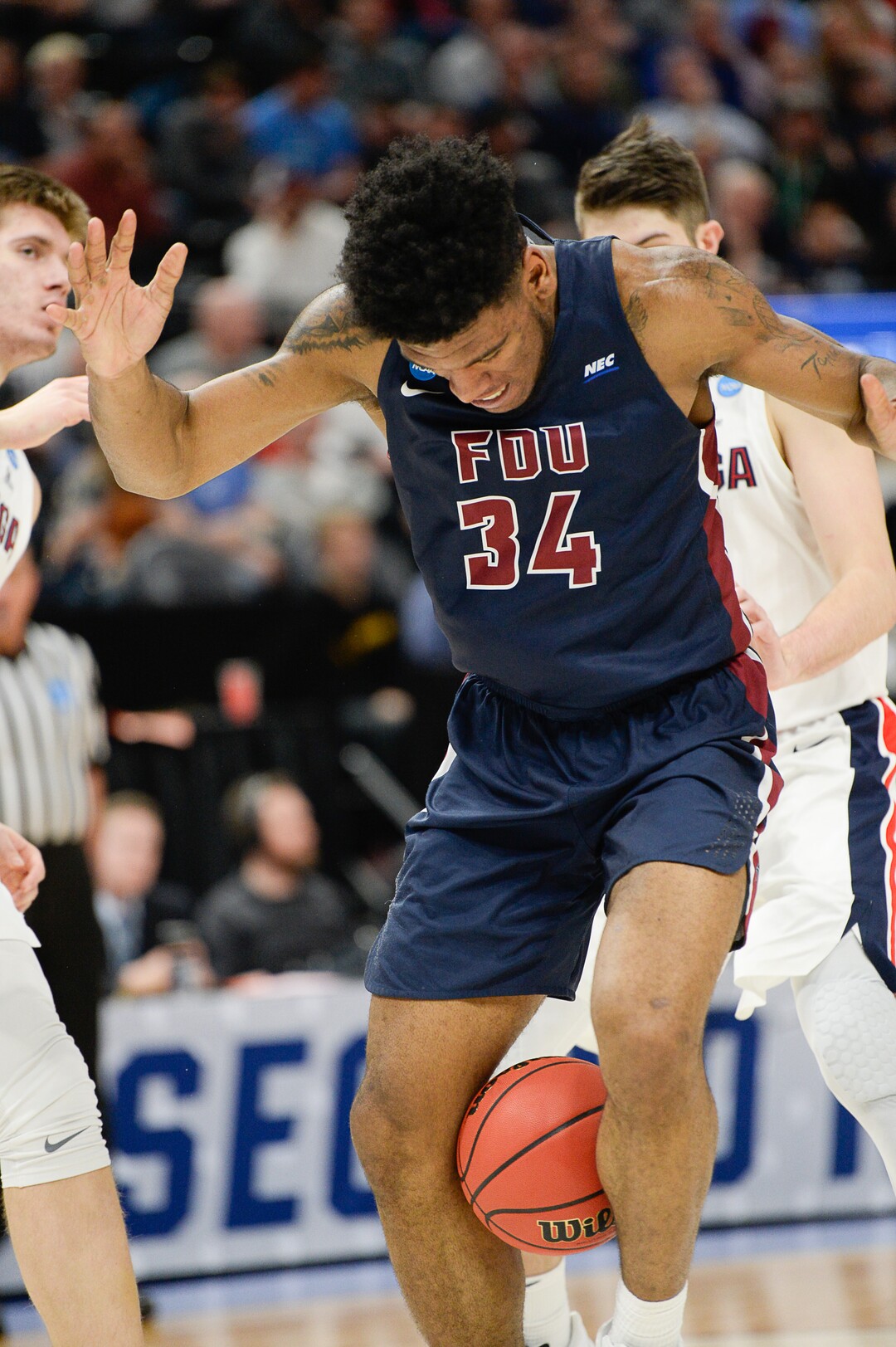 (Francisco Kjolseth  |  The Salt Lake Tribune)  Fairleigh Dickinson Knights forward Mike Holloway Jr. (34) tries to keep hold of the ball with his legs as Gonzaga faces Fairleigh Dickinson in their first round menÕs NCAA March Madness tournament game at Vivint Smart Home Arena in Salt Lake City on Thursday, March 21, 2019.