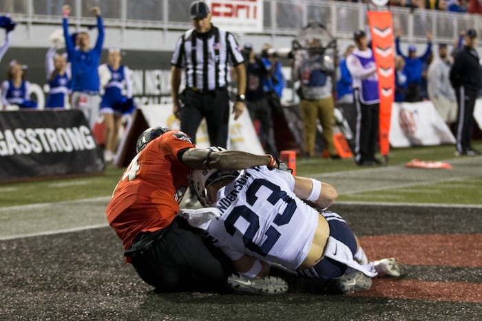BYU defensive back Zayne Anderson (23) makes an interception against UNLV wide receiver Kendal Keys (84) during an NCAA college football game Friday, Nov. 10, 2017, in Las Vegas. (Erik Verduzco/Las Vegas Review-Journal via AP)