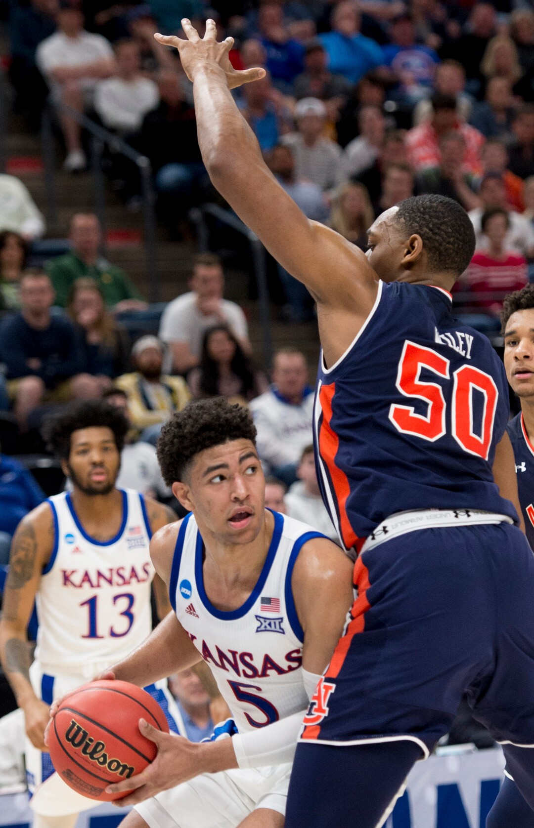 (Leah Hogsten  | The Salt Lake Tribune)  Kansas Jayhawks guard Quentin Grimes (5) looks to get rid of the ball under pressure from Auburn Tigers center Austin Wiley (50) as Auburn faces Kansas in the second round of the NCAA tournament in Salt Lake City on Saturday, March 23, 2019.