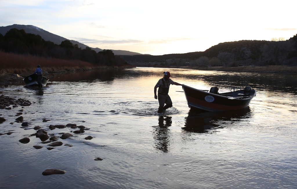 (Francisco Kjolseth  |  The Salt Lake Tribune) A long day on the river comes to a close as river guides move boats into position to pack onto trailers after a float down the B section of the Green River, from Little Hole to Indian Crossing.