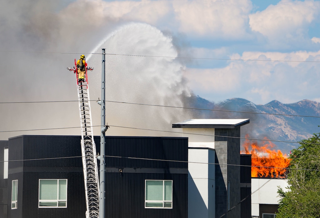 (Francisco Kjolseth | The Salt Lake Tribune) Crews battle a fire at North Union Apartments in Midvale on Friday, July 31, 2026. Firefighters brought the blaze under control Saturday, but it will be several days before evacuated residents can return to grab belongings and vehicles.
