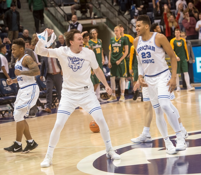 (Rick Egan  |  The Salt Lake Tribune)  Brigham Young Cougars  celebrate their win over the San Francisco Dons in overtime, in basketball action at the Marriott Center, Saturday, February 10, 2018.