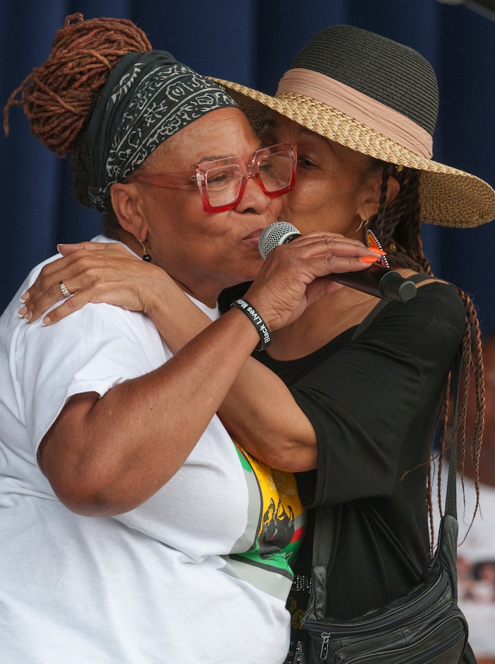 (Leah Hogsten | The Salt Lake Tribune) l-r Betty Sawyer, the Director of the African-American community group Project Success Coalition, gets a hug and a kiss from Dr. Jackie Thompson at the Utah Juneteenth Festival at the Ogden City Amphitheater, Saturday, June 18, 2022. This year marks the 33th Annual Juneteenth and Utah Freedom & Heritage Festival.