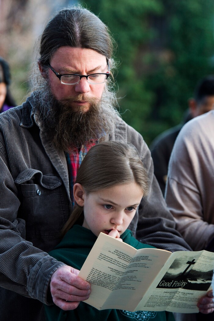 (Rick Egan  |  The Salt Lake Tribune)     Joe Gibbs and 10-year-old Rosie Gibbs read a scripture during one of the stops, as clergy and members of Christian denominations participate in the annual Good Friday procession through downtown Salt Lake City, Friday, March 30, 2018. The procession commemorating Christ's path to crucifixion has been a tradition of the Salt Lake Council of Churches since 1988. 


