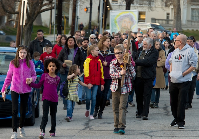 (Rick Egan  |  The Salt Lake Tribune)     Cal Burke, 11, and Grace Carlson, 12, from Layton, carry the cross as members of Christian denominations participate in the annual Good Friday procession through downtown Salt Lake City, Friday, March 30, 2018. The procession commemorating Christ's path to crucifixion has been a tradition of the Salt Lake Council of Churches since 1988. 


