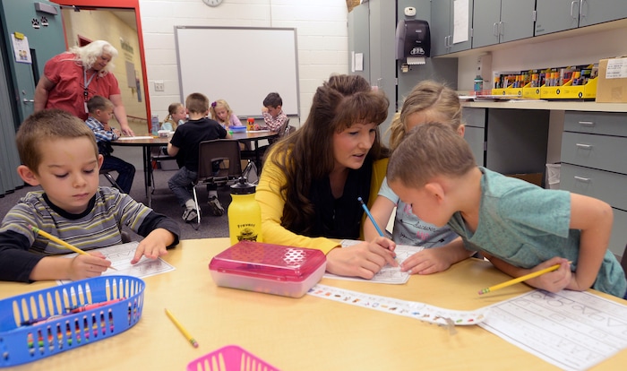 (Al Hartmann | The Salt Lake Tribune) Melissa Morris helps kids at Park Valley School with penmanship and drawing the alphabet Wednesday August 30.