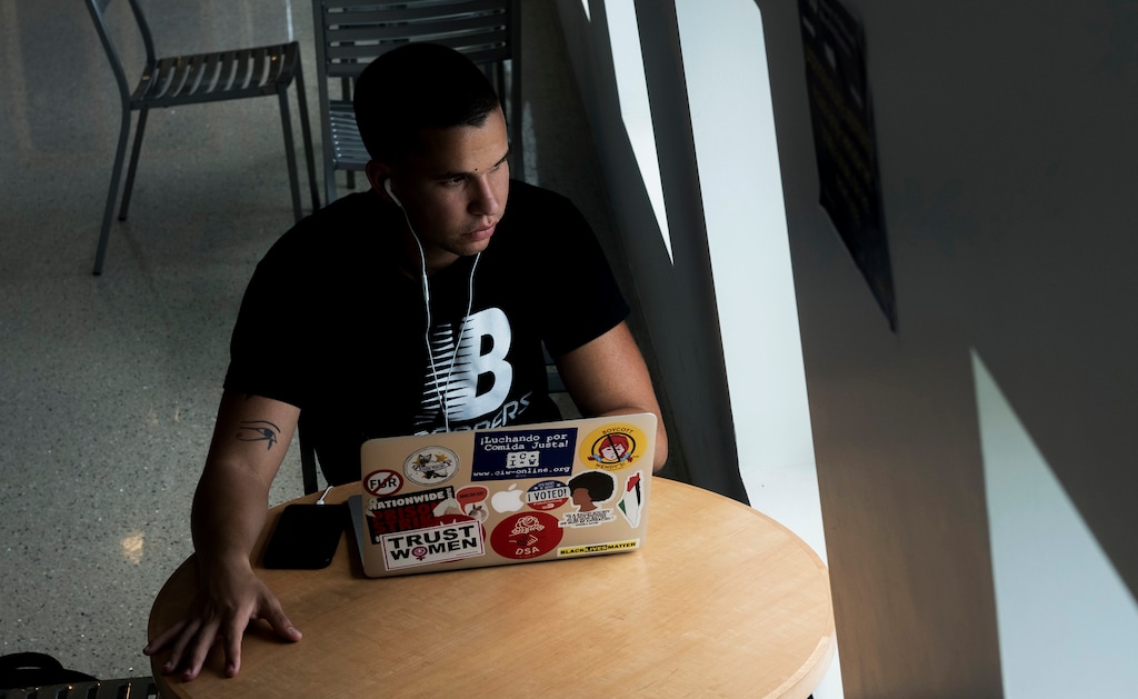(AP Photo/Ellis Rua) In this June 26, 2019, photo, Andy Vila, 21, speaks to callers who have phoned in to an anonymous know-your-rights hotline for immigrants who are in Miami illegally. He says his generation is more concerned with solving current problems than fighting past ideological wars.