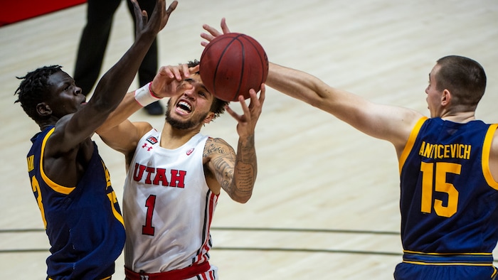 (Rick Egan | The Salt Lake Tribune) Utah Utes forward Timmy Allen (1) goes up for a shot, as California Golden Bears forward Kuany Kuany (13) and California Golden Bears forward Grant Anticevich (15) defend, in PAC12 Basketball action between the Utah Utes and the California Golden Bears, on Wednesday, Jan. 16, 2021.