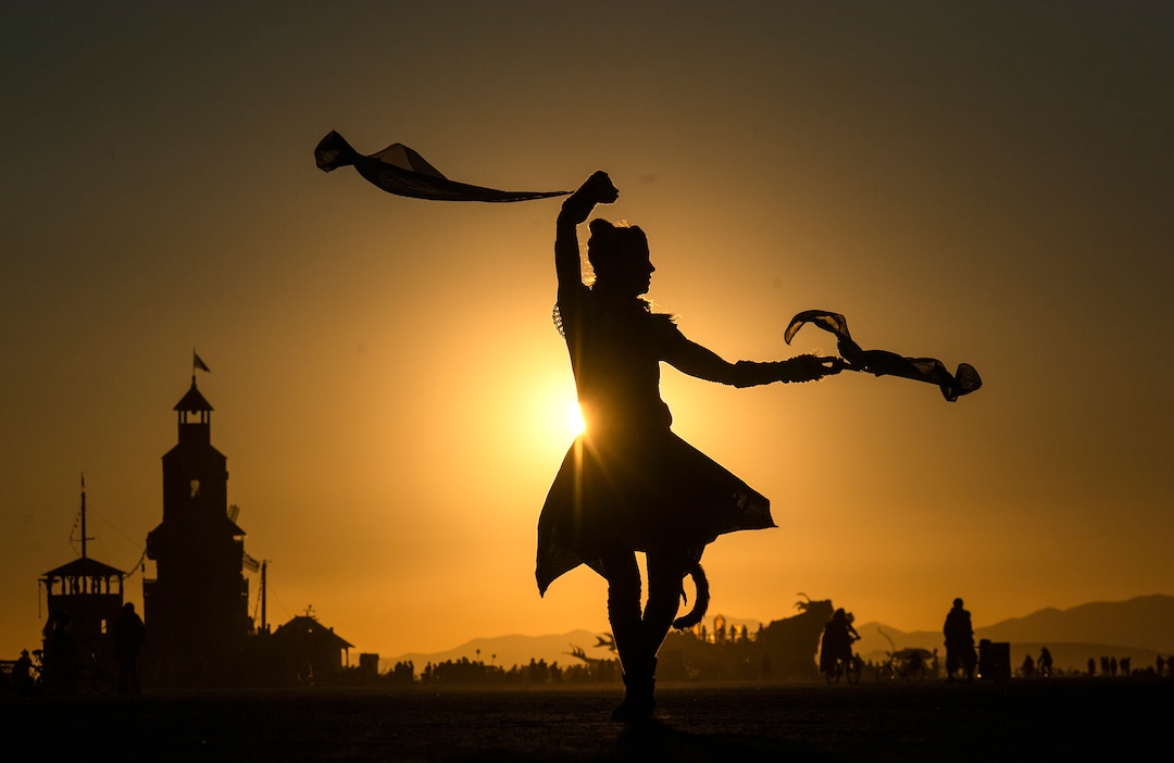 (Rick Egan  |  The Salt Lake Tribune)   Claire Dawn from North West, Minnesota, dances at sunrise, at Burning Man, in the Black Rock Desert, in Nevada. Friday, Aug. 30, 2019.