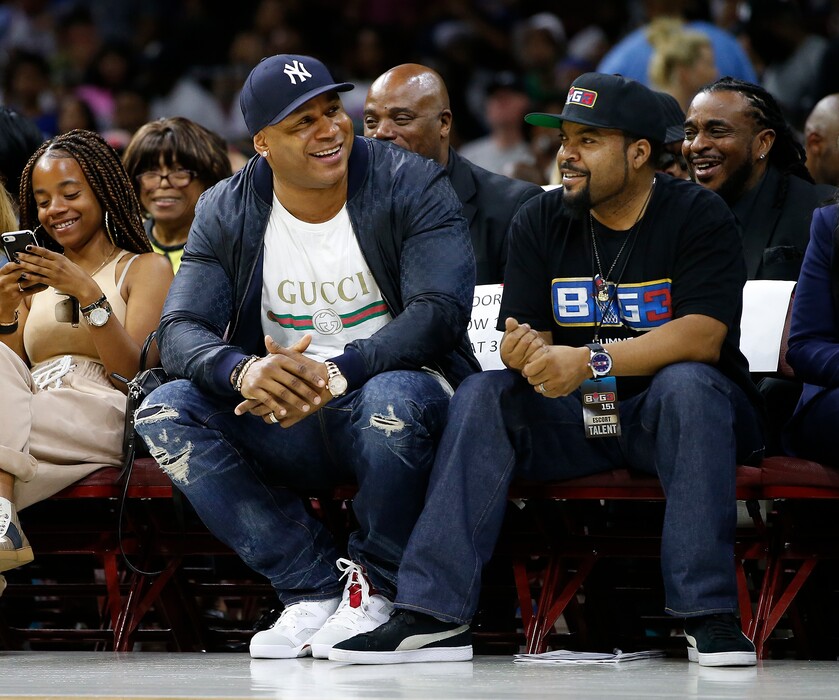 LL Cool J, second from front left, and Ice Cube watch the action as The Power plays the Ghost Ballers during the first half of Game 1 in the BIG3 Basketball League in Philadelphia, Pa., Sunday, July 16, 2017. (AP Photo/Rich Schultz)