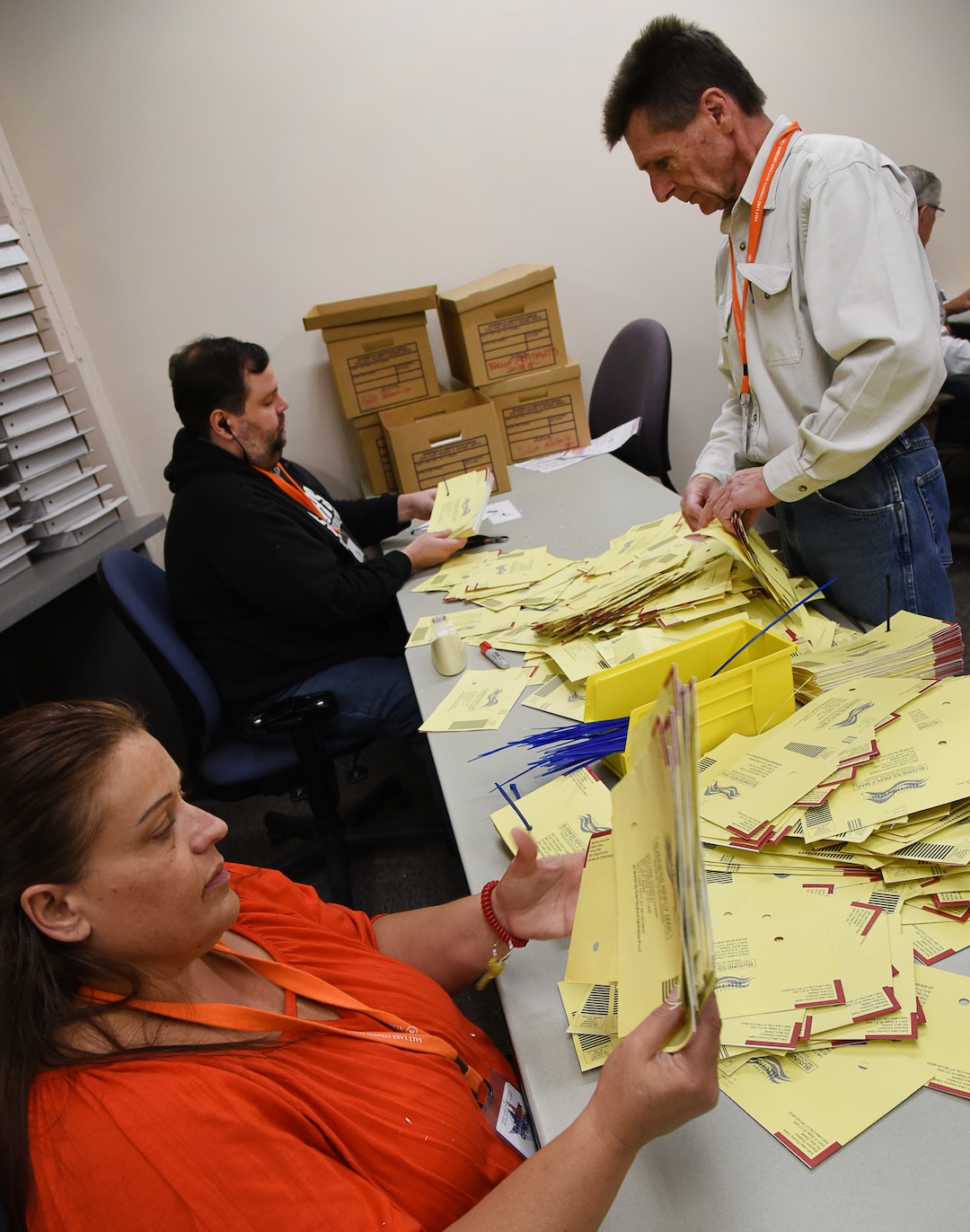 (Francisco Kjolseth  |  The Salt Lake Tribune)  Temporary elections workers Tanya Holguin, Erik Dryden and Joe Locurto, from left, line up envelopes with a strategically set hole to make sure there are no remaining ballot contents while sorting mailed in ballots on Tuesday, Oct. 31, 2018. Turnout numbers from the State Elections Office showed 359,219 people out of 1,390,679 active Utah voters have already cast their ballots as of Tuesday morning. Ten Salt Lake County early voting locations will open on Wednesday, but 1,059 voters have already taken advantage of voting at the Salt Lake County government offices. While many have already cast their ballots, there are some Utahns who haven't received theirs in the mail yet, which may create obstacles for them to vote.