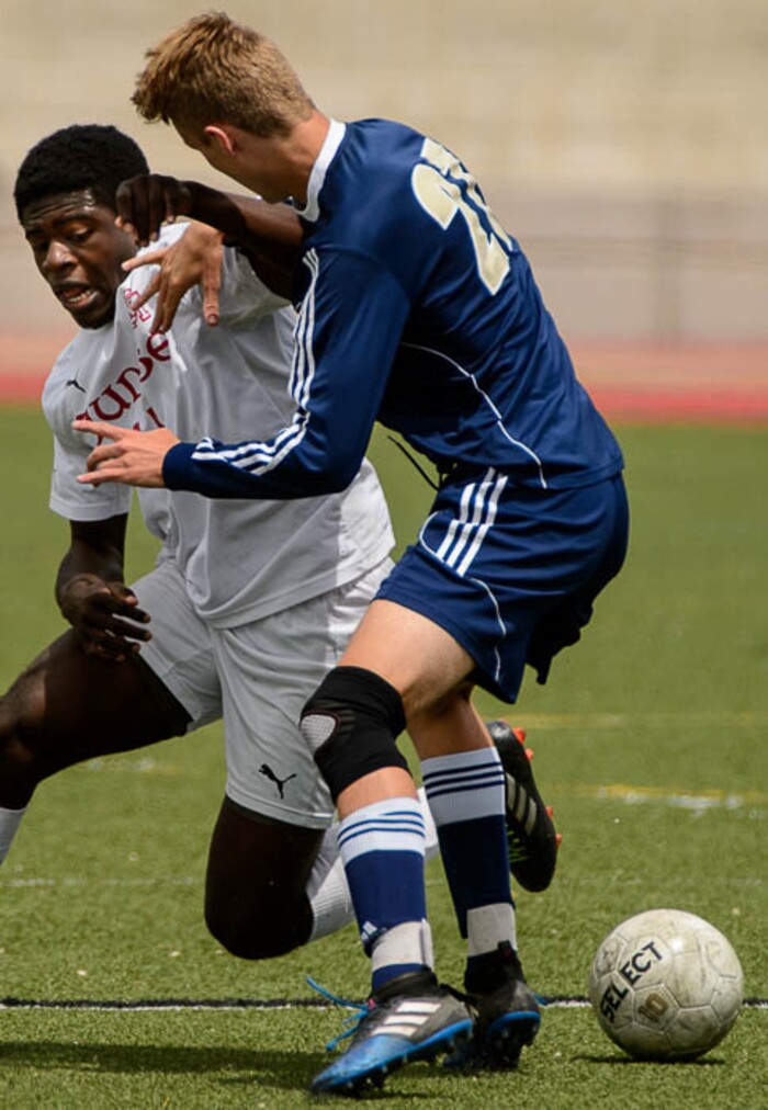 (Trent Nelson | The Salt Lake Tribune)  Judge Memorial's Gedeon Baende (11) and Maeser Prep's Thomas Vick (27) in the Class 3A boys' soccer state quarterfinal between Judge Memorial and Maeser Prep in Salt Lake City, Saturday May 5, 2018.