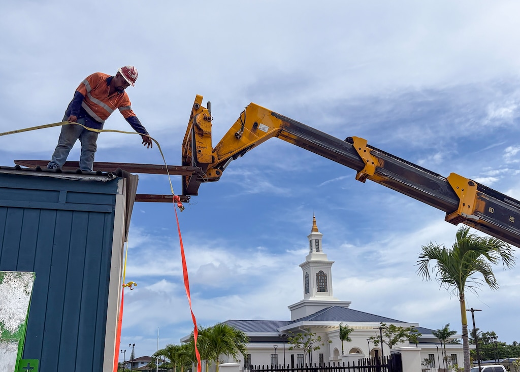(Matthew D. LaPlante | Special to The Tribune) Kaia Kaisa helps unload construction supplies at the soon-to-be-opened Latter-day Saint temple in Tafuna, American Samoa.