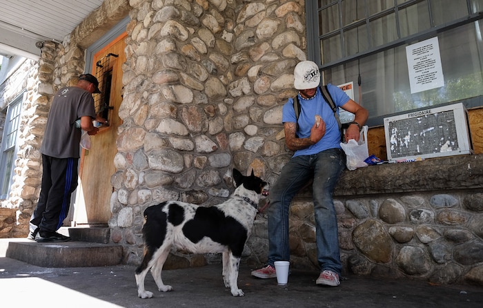 (Francisco Kjolseth  |  The Salt Lake Tribune)  People pick up a sack lunch at the Good Samaritan House at 347 E. South Temple on Tuesday, Aug. 27, 2019. After 32 years of serving sack lunches 365 days a year for 11 hours a day to Utah's poor, the Good Samaritan will be closing down, absorbed into the Catholic church's operations at St. Vincent's.