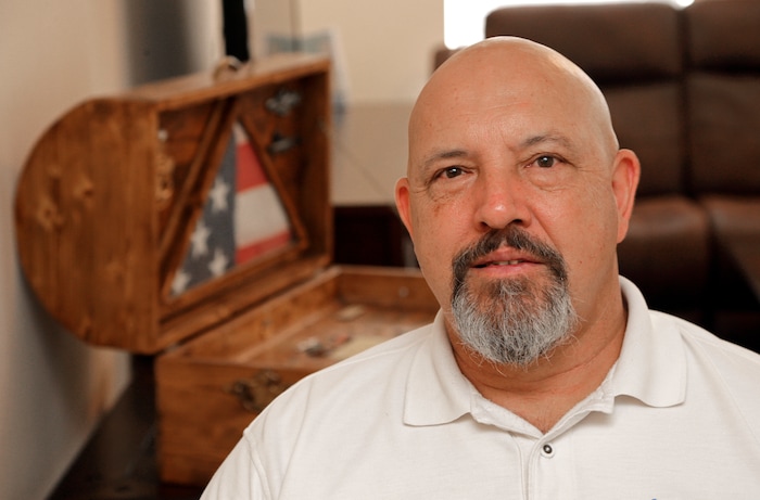 Former Word of Faith Fellowship church member Rick Cooper poses for a photo at his home in Charlotte, N.C., Monday, Sept. 18, 2017. He and 10 other members of the evangelical North Carolina-based church say their leader, Jane Whaley, coerced congregants into filing false unemployment claims after the faltering economy threatened weekly tithes from church-affiliated companies. “Every week we’d go to the unemployment office and put down that we looked for work at other companies operated by Word of Faith Fellowship leaders,” Rick Cooper said. “Those companies would vouch for the Word of Faith members at the unemployment offices. It was a conspiracy." (AP Photo/Chuck Burton)